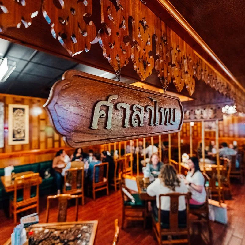 Sushi-Thai dining room with a carved hanging sign